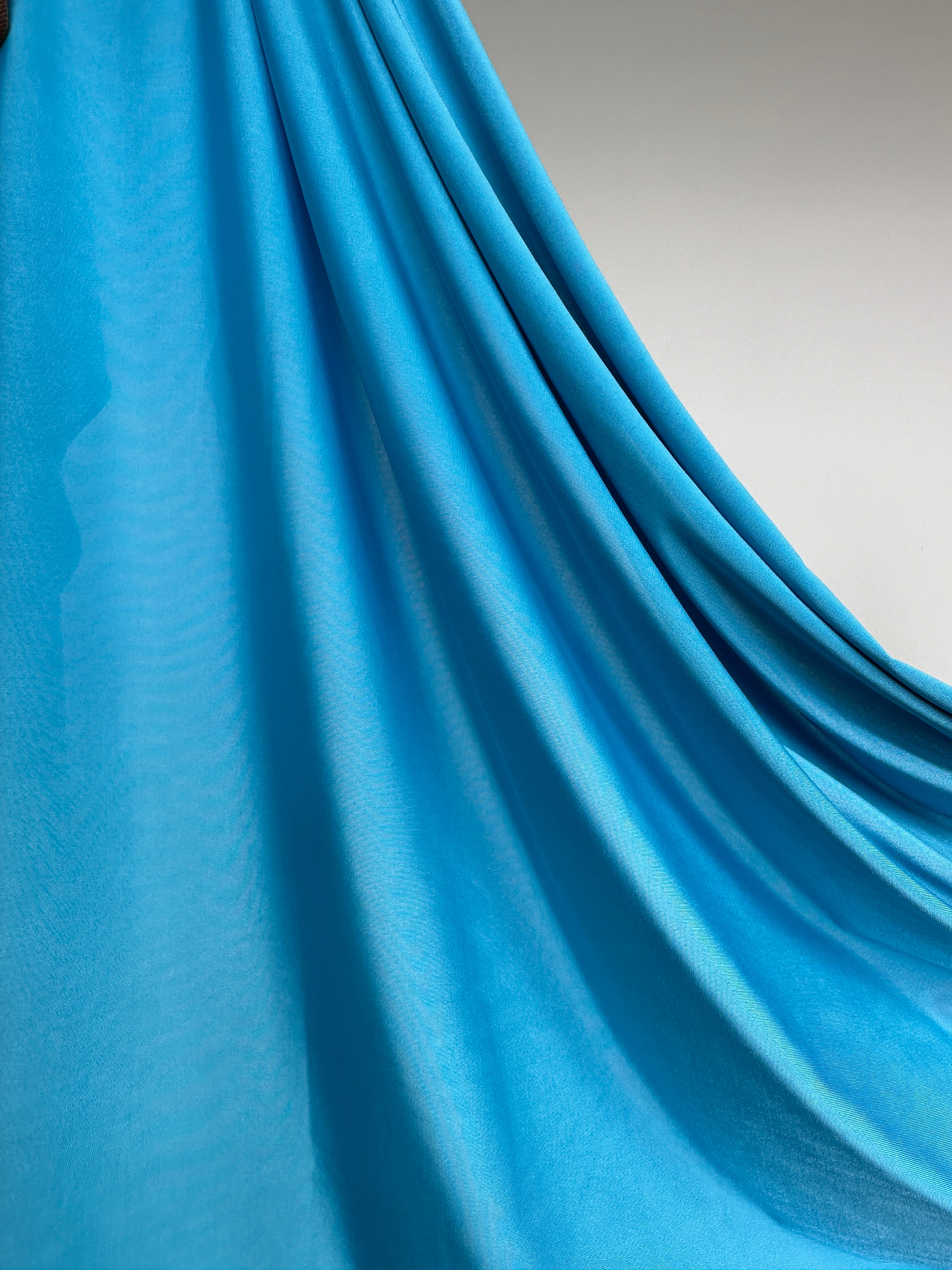 Détail de la couleur bleu azur sur tissu jersey liquide doux.